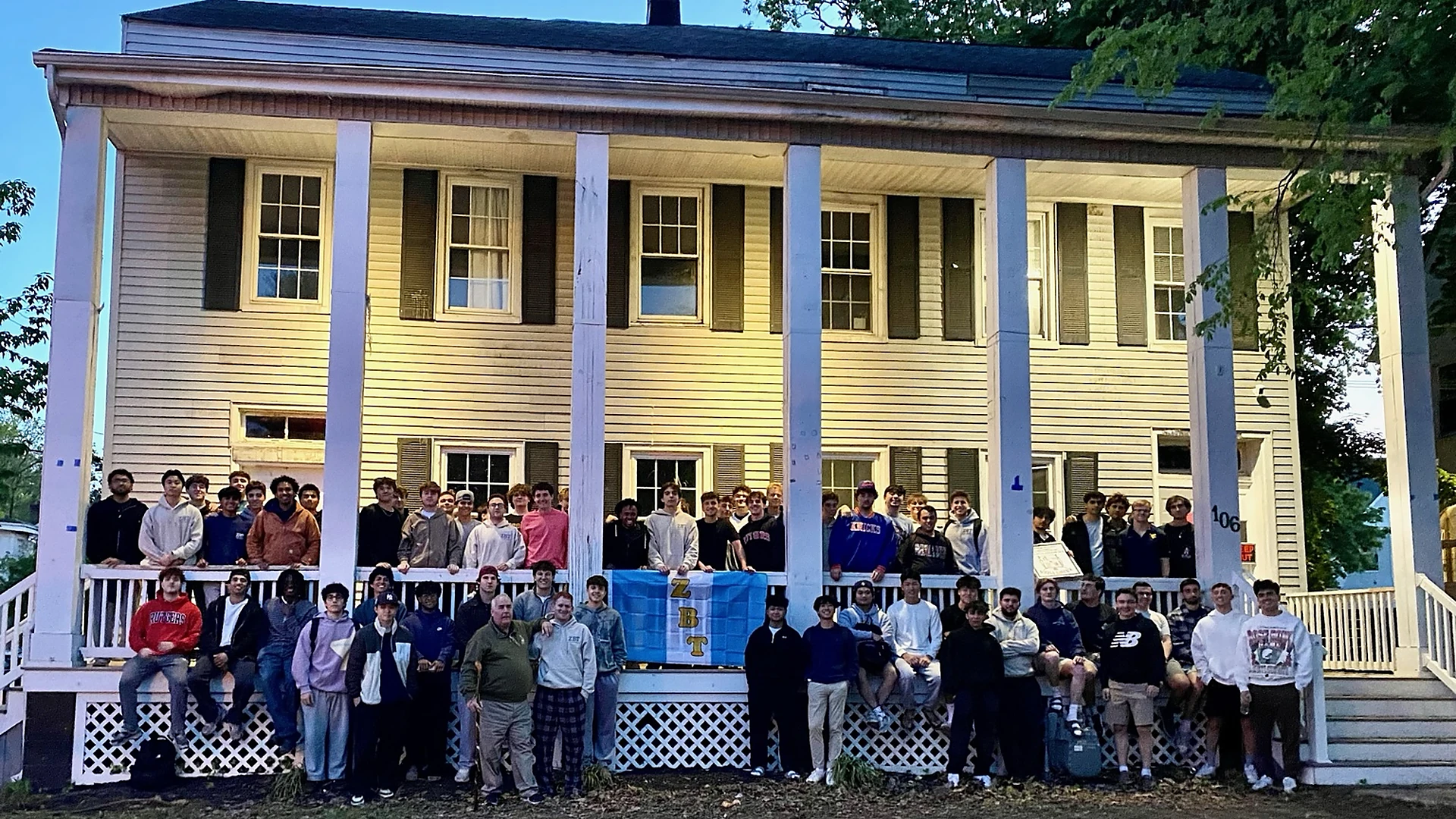 Beta Delta brothers gathered outside 106 College Avenue
