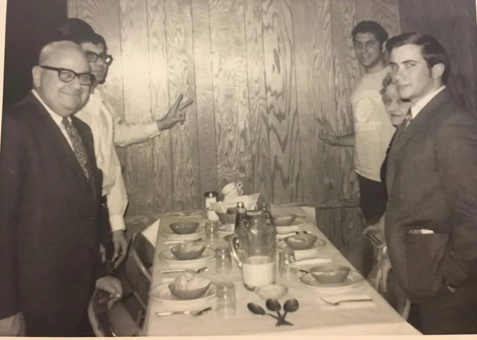 Joe Glaser sharing a meal with Beta Delta brothers