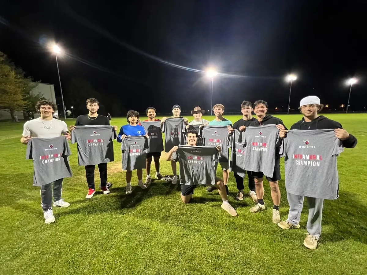 Beta Delta intramural softball champions holding championship shirts